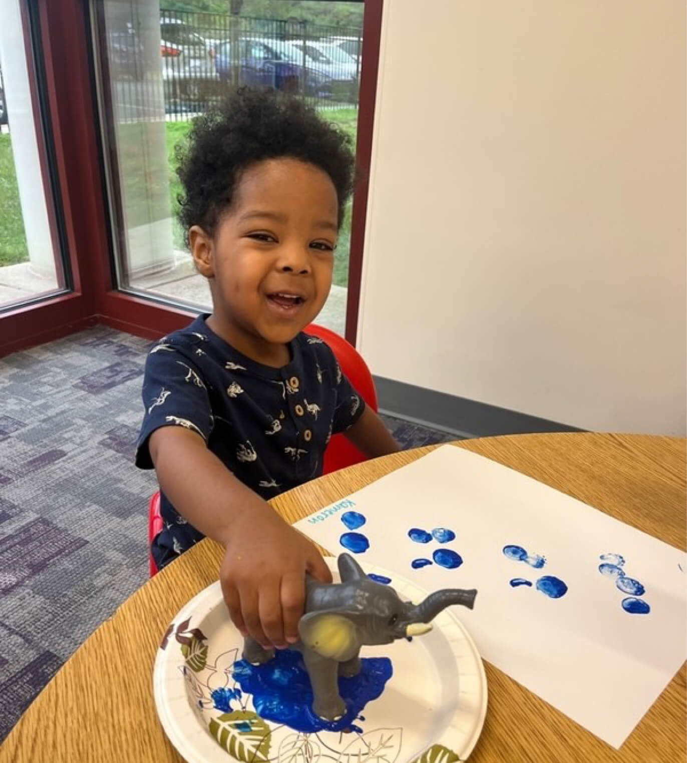 Child playing with paint and toys